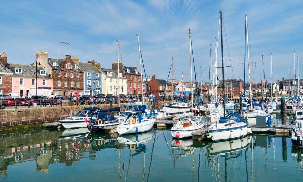 Boats moored on a sunny dock