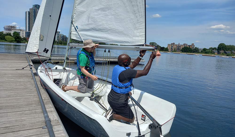 wideshot of Ladi fixing a boat