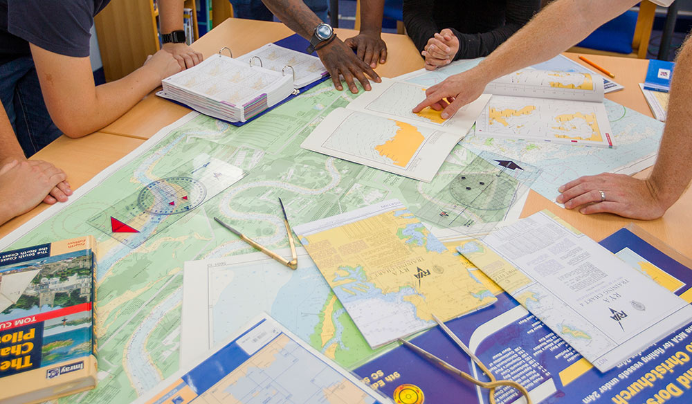 closeup of people looking at charts as part of a training exercise 