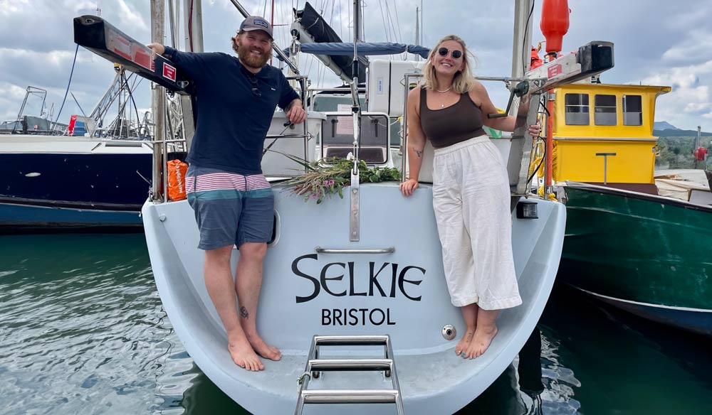 Couple stood on the back of their boat