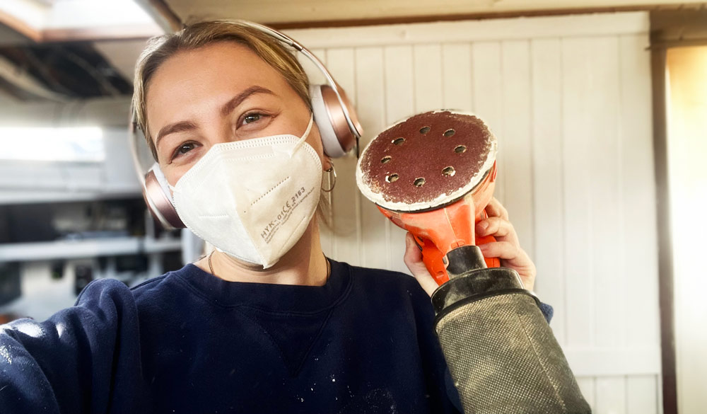 Woman holding power tool on boat