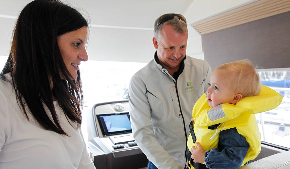 wide shot of baby wearing a life jacket