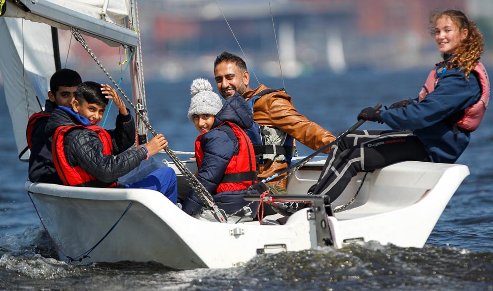 Family on a keelboat during winter