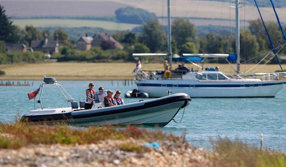 Rib and yacht sailing together 