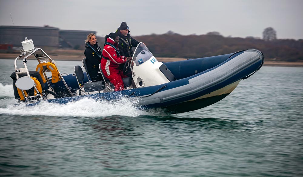 RIB on the water with three people on it