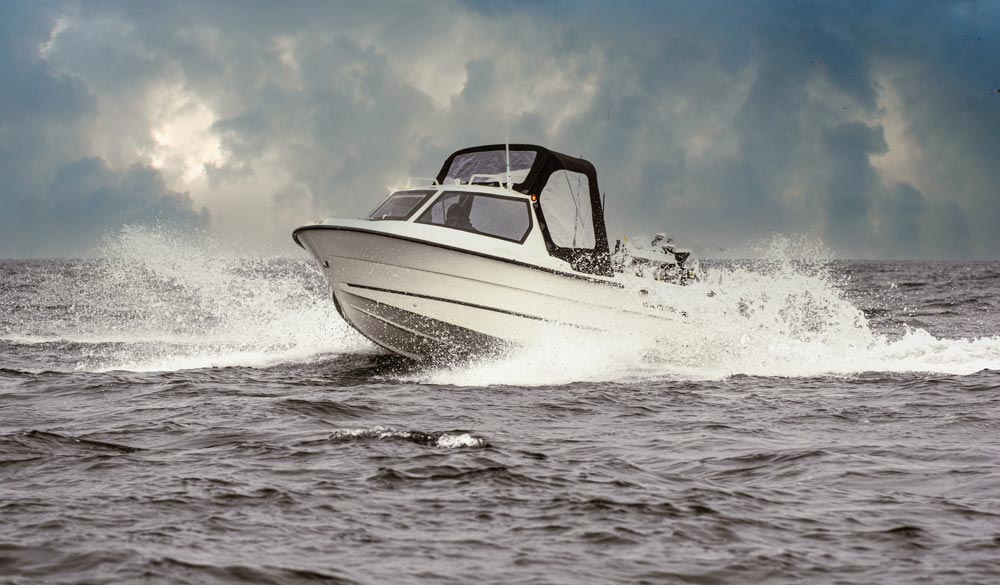 Powerboat sailing in rough weather wind and waves