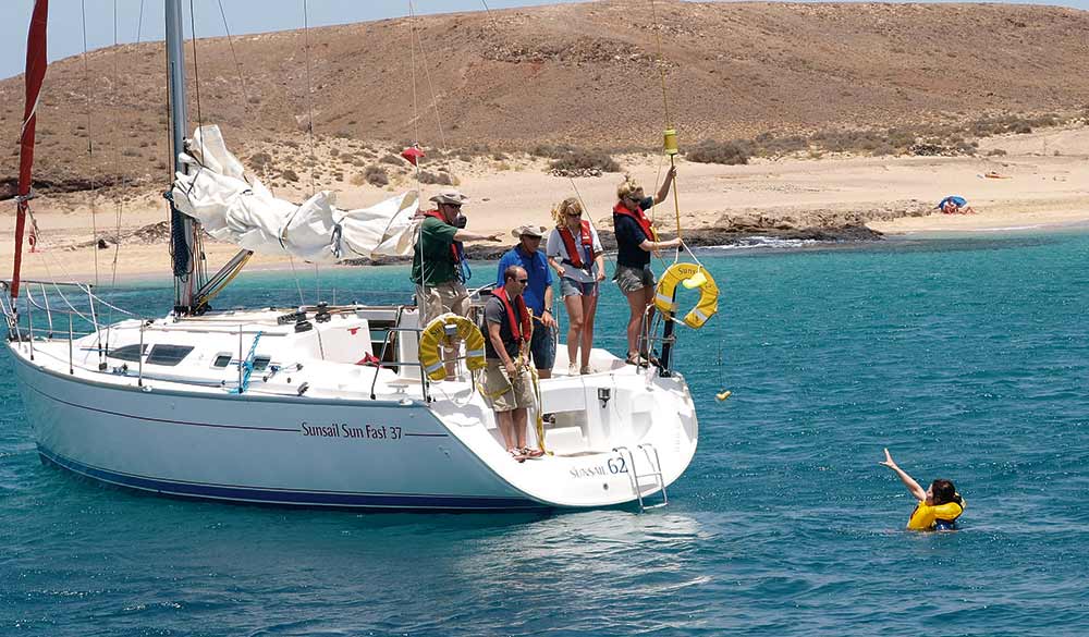 someone waving to yacht after they have fallen overboard - man overboard