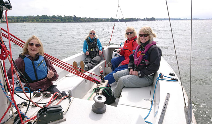 4 women sailing on a lake