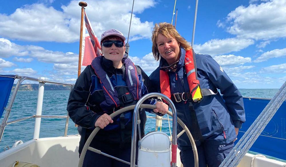 two visually impaired members helming a yacht