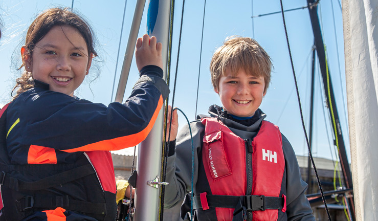 Child welfare survey two children smiling on a dinghy