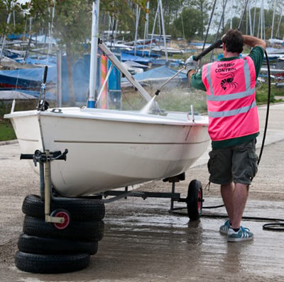 shot of man spraying boat to remove shrimps