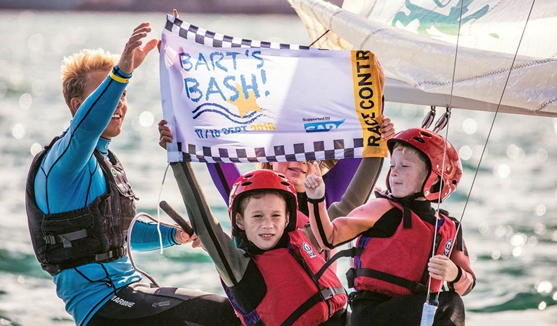 children holding up a Bart's bash sign