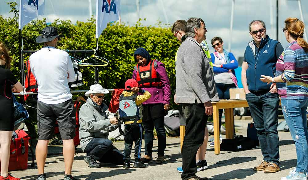 observational shot of volunteers preparing for an event at a club in the sun