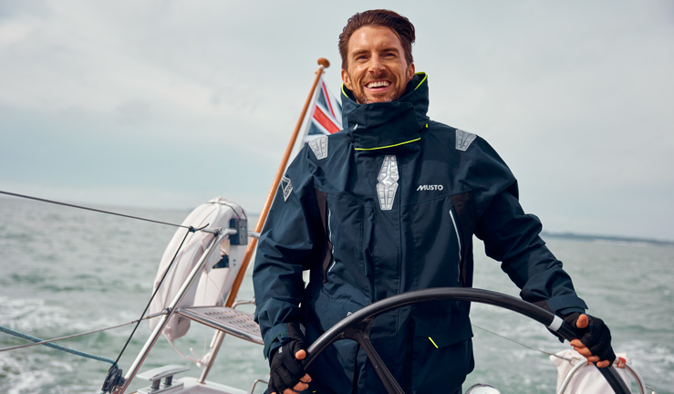 Man sailing with a Musto jacket whilst on the open water