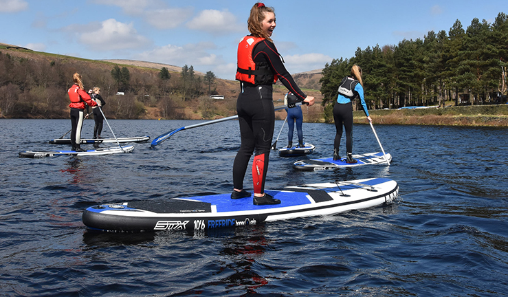 Young people paddle boarding at Glossop Sailing Club