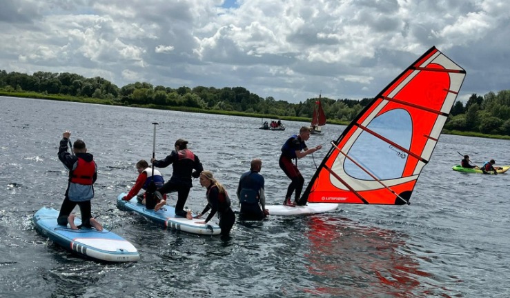 A group of scouts trying out different activities in the lake