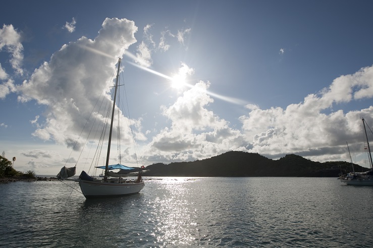 A yacht sits at anchor 