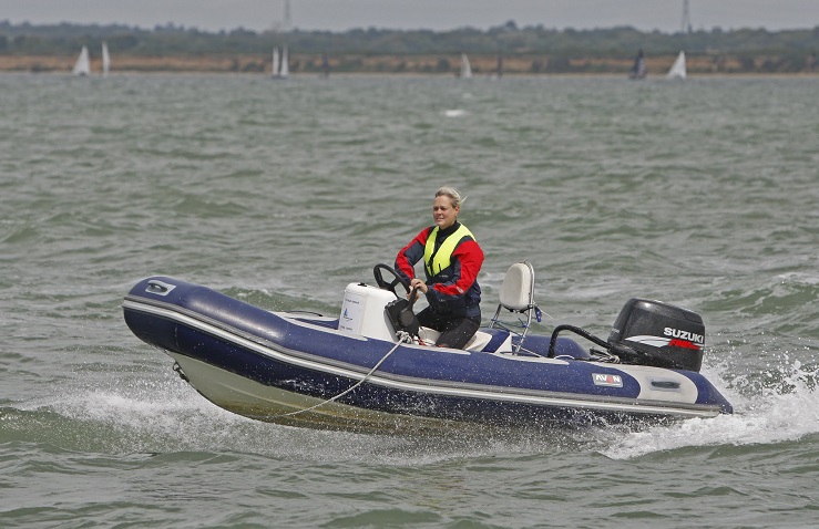 A woman enjoying the water on a powerboat