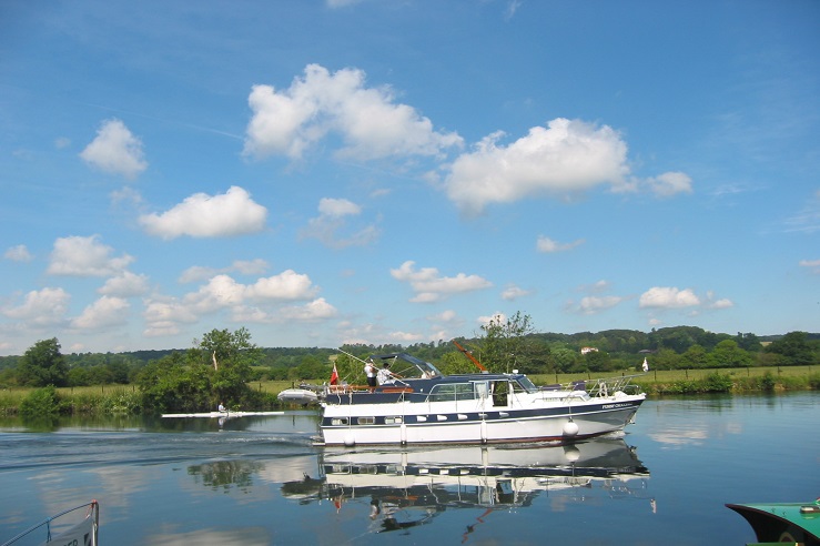 Motor boat cruises along a stretch of inland water