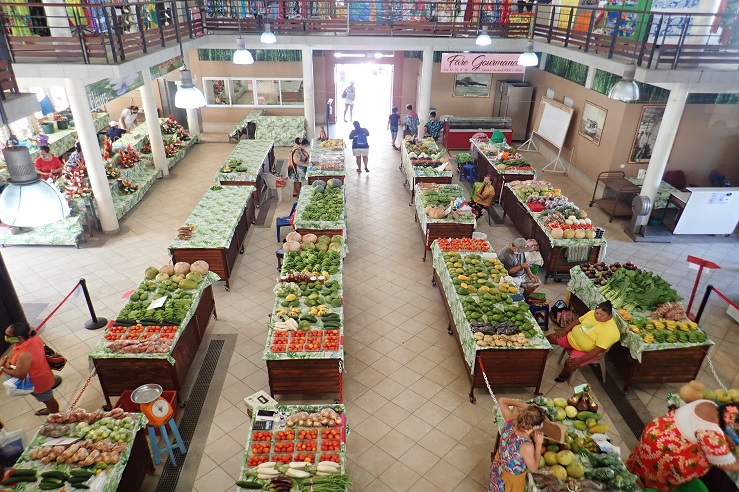 Fruit and vegetables are displayed on tables at a supermarket