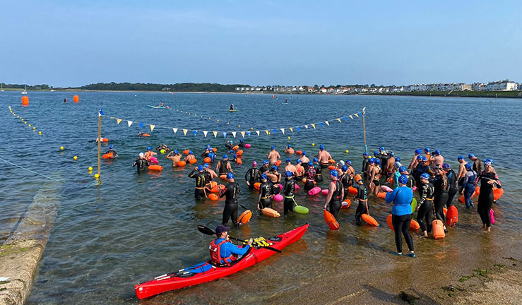 wide shot of swimming competition in lake