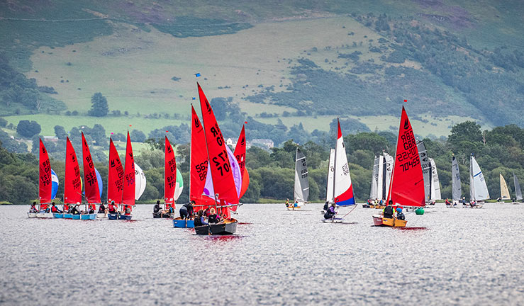 wide shot of sailing boats on lake