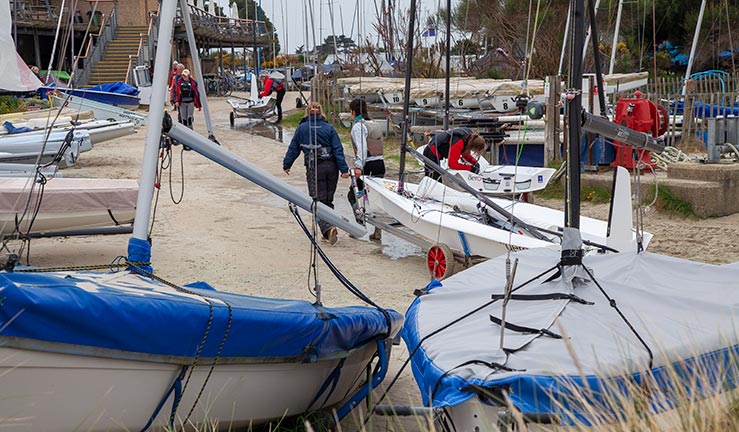 wide shot of boats parked up on land outside club