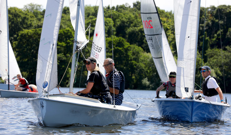 Club member motivation. Two couples dinghy racing at their local club. 
