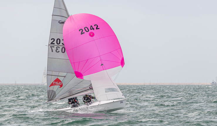 Dinghy with pink spinnaker. Pinnell and Bax