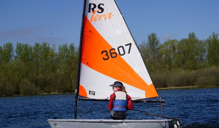 A youngster in a dinghy on the water