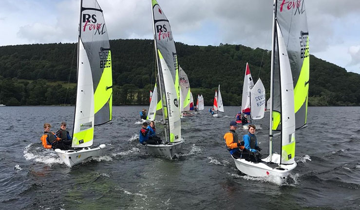 Coached regatta fleet of mixed dinghies, led by three RS Fevas, at the BYS North Junior Champs Regatta Fleet at Ullswater 2022.
