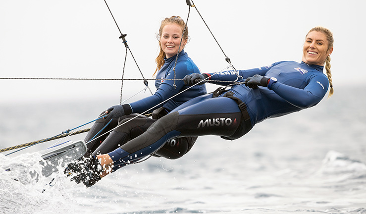 dynamic close-up of two tall women competing in skiff race