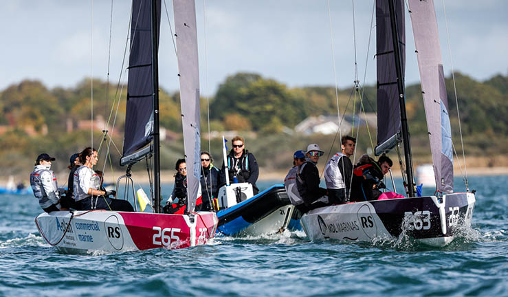 Two teams match racing upwind in RS21 keelboats at RYA finals 2022 with umpire RIB.