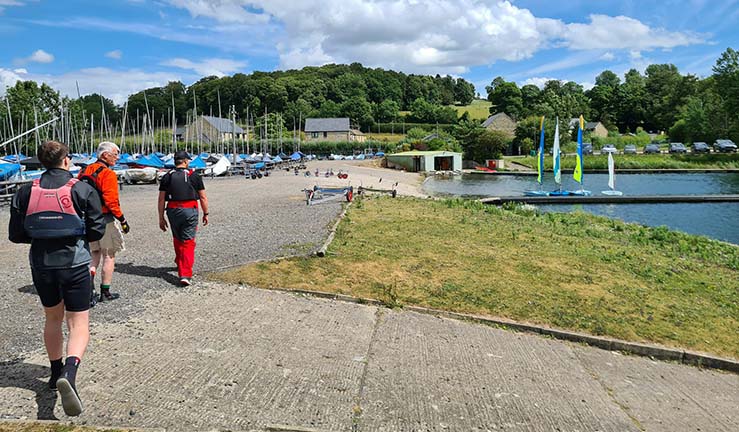 Instructors heading out to boats moored on a pontoon in RYA NE region.
