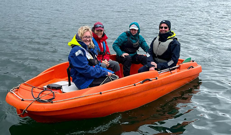 Three Midlands region aspiring female powerboat instructors in a RIB with project lead Sallie Bowd who is seated at the front.