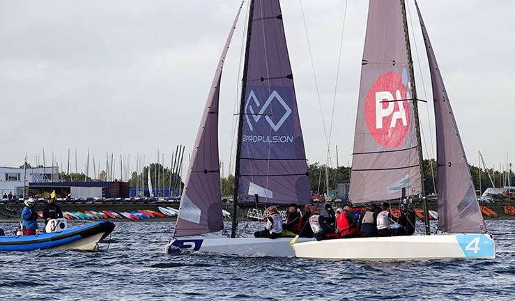 Two teams racing RS21s upwind with an umpire RIB following at the RYA National Match Racing finals 2023 at Queen Mary SC.
