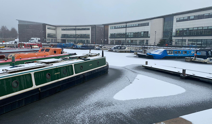 Canal Boats sitting in the Snow
