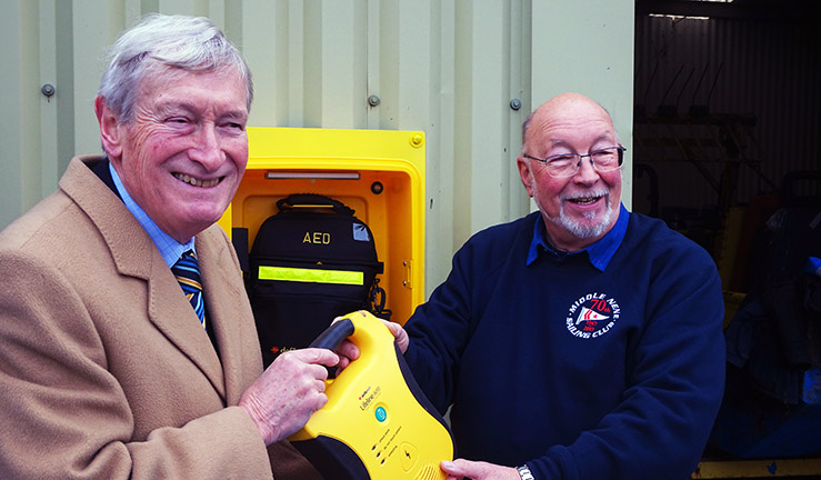 Chairman of national charity RALPHH, Richard Allen, presents defibrillator to Middle Nene SC Commodore Tony Wright.