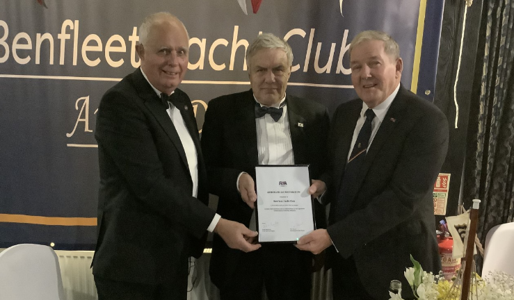 Doug MacEwen, Chair of the RYA East Committee presents an RYA East certificate of recognition to celebrate 100 years of Benfleet Yacht Club to John Hancock, Commodore of Benfleet Yacht Club. Also pictured is Charles Anderson, Deputy Lord Lieutenant of Essex