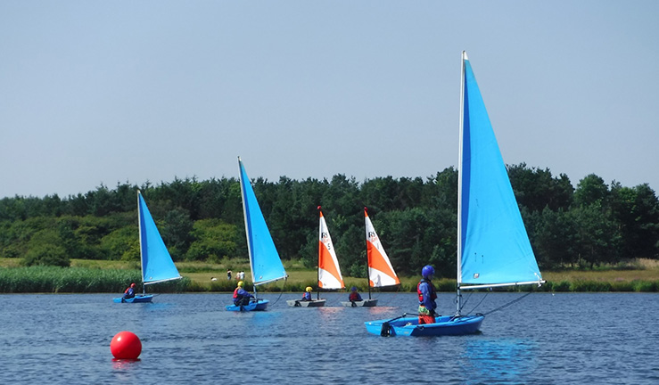 Coquet Shorebase Trust junior sailing boats on the water