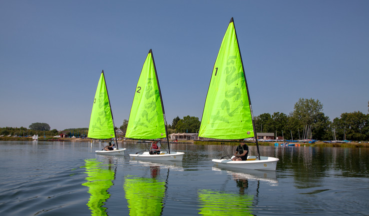 3 RS Zest dinghies sailing on a lake