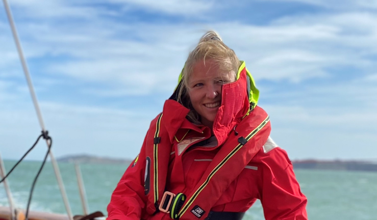 Woman in red sailing jacket on yacht