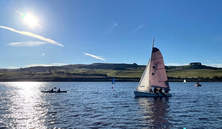 Dinghy and kayak on the water at Teesdale SWC for UTASS visit summer 2022