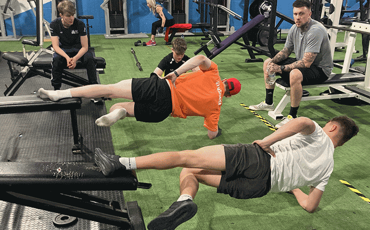 NI sailors with coach Chris Penney taking part in strength and conditioning training. 