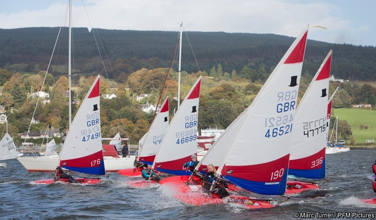 A fleet start of Topper dinghies by a start vessel