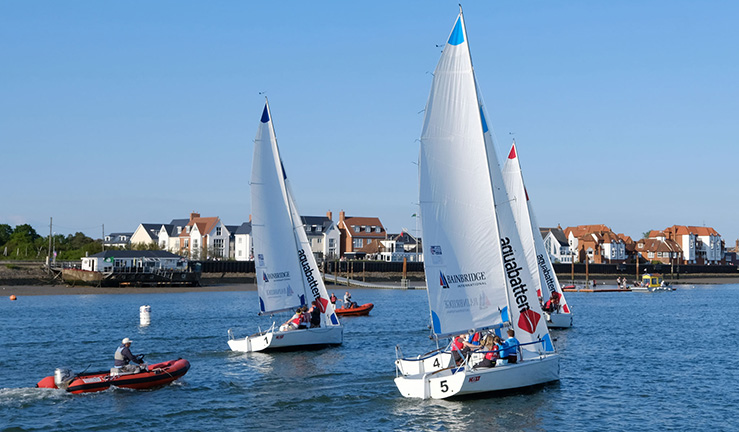 Four 707 keelboats racing upwind on River Crouch on sunny day with an umpire's RIB just behind them at British Keelboat League event Burnham 2021.