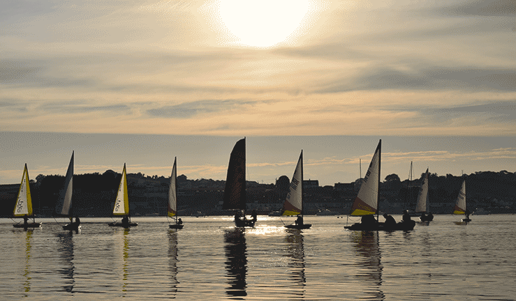 Boats taking part in a Bright Night sailing programme