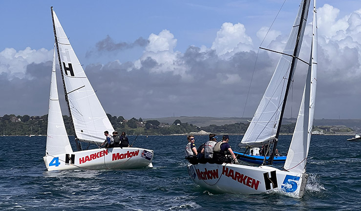 Two teams aboard Elliott 6m keelboats match racing upwind in Portland Harbour for the RYA Harken Youth Match Racing Championship 2023
