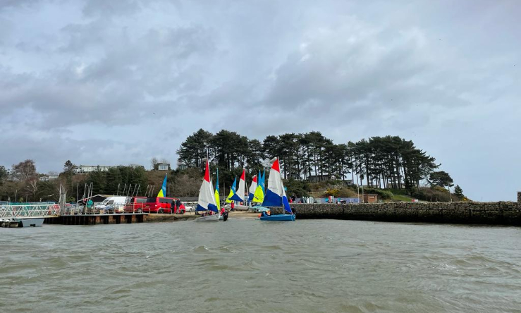 Dinghies on a pontoon with trees behind