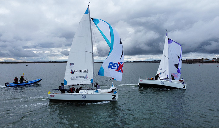 Two teams aboard 707 keelboats match racing on downwind leg with spinnakers at Burnham.